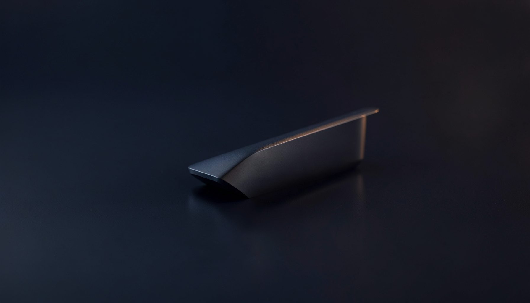 Sleek minimalist product display on a dark matte surface with subtle reflections, deep navy and gunmetal tones with soft highlights